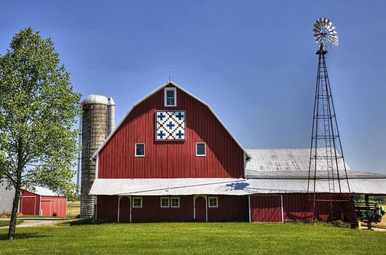white and blue barn quilt on red barn